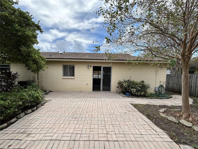 back of property with a patio