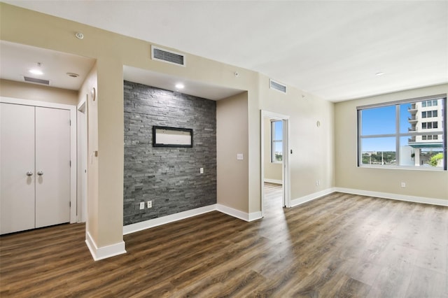 unfurnished living room featuring dark wood-type flooring