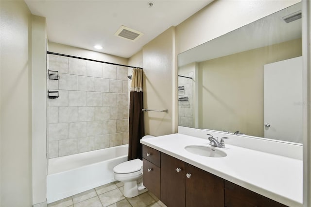 full bathroom with tile patterned flooring, toilet, shower / tub combo with curtain, and vanity