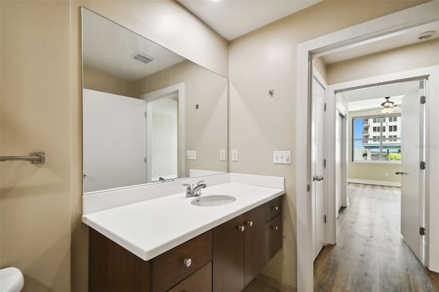 bathroom featuring vanity, ceiling fan, and hardwood / wood-style flooring