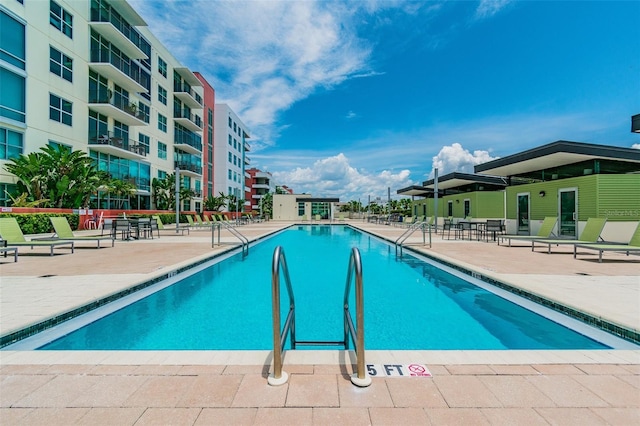 view of swimming pool featuring a patio area