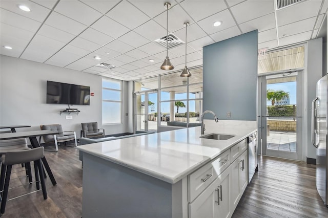 kitchen featuring pendant lighting, a healthy amount of sunlight, sink, and dark wood-type flooring