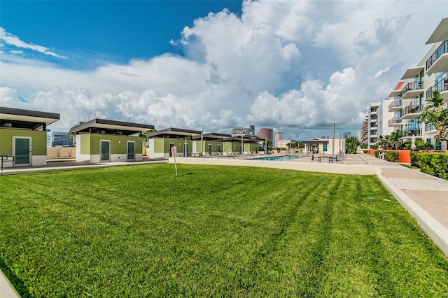 exterior space with a yard and a swimming pool