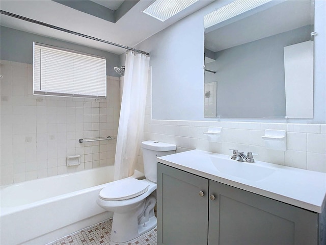 full bathroom with toilet, vanity, tile patterned floors, tile walls, and shower / tub combo with curtain