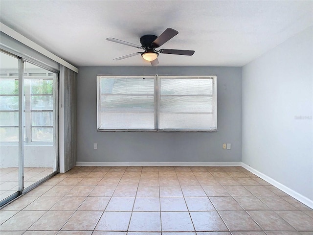 empty room featuring ceiling fan and light tile patterned floors