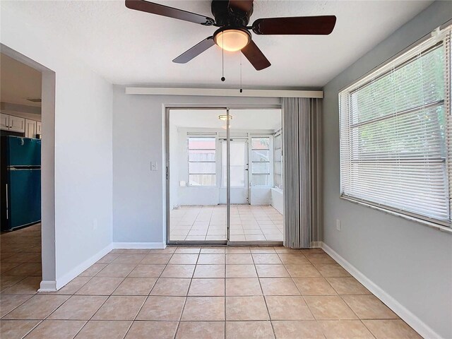 tiled empty room with ceiling fan