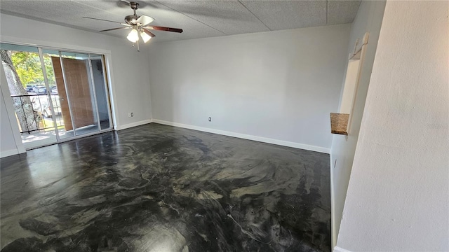 empty room featuring ceiling fan and a textured ceiling