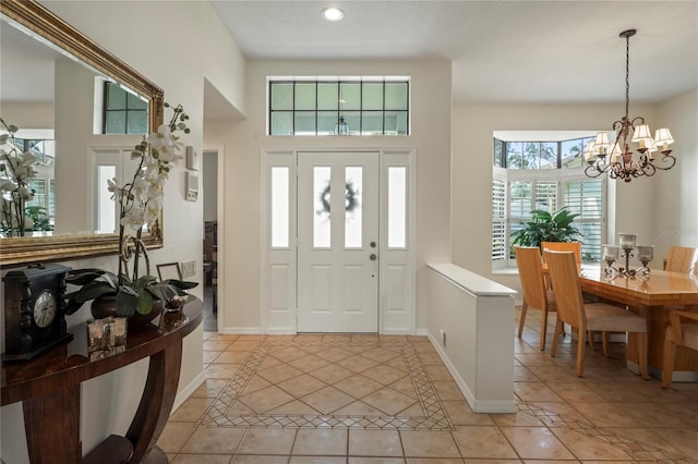 entrance foyer featuring a chandelier and light tile patterned floors