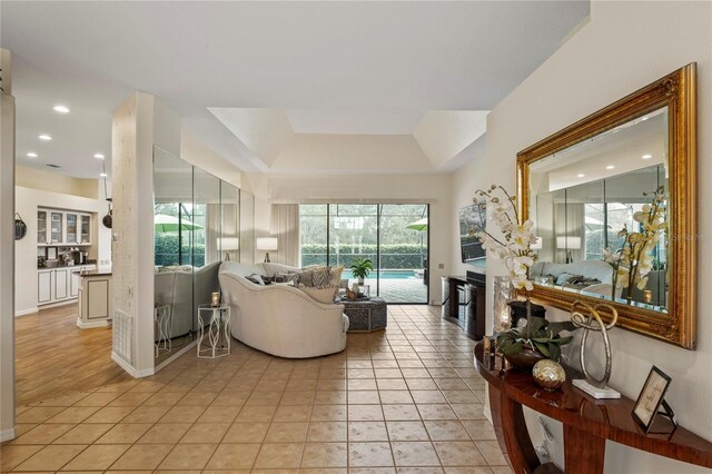 tiled living room with a raised ceiling