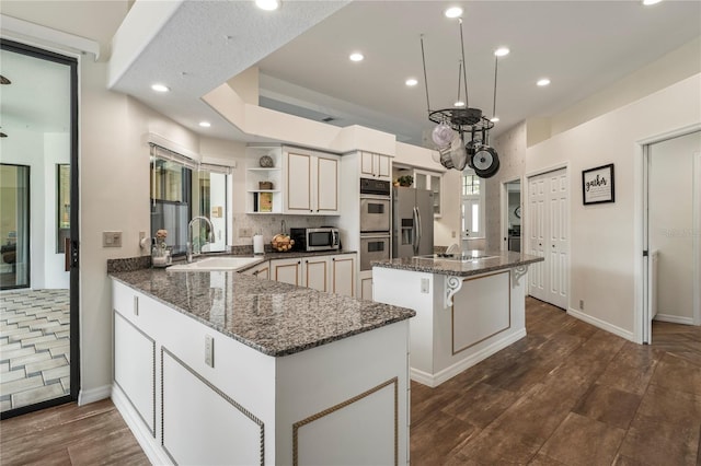 kitchen with appliances with stainless steel finishes, sink, tasteful backsplash, and plenty of natural light