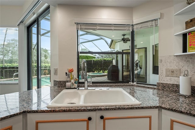 kitchen featuring white cabinets, plenty of natural light, and sink