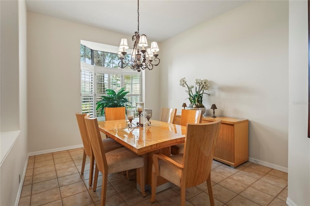 dining space featuring light tile patterned floors and a notable chandelier