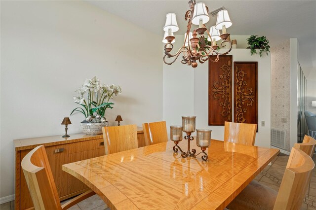 dining room with tile patterned flooring and a chandelier