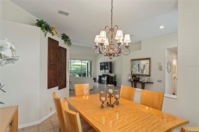 tiled dining space featuring a notable chandelier