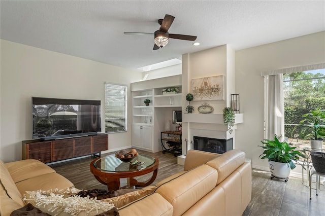 living room with ceiling fan and a textured ceiling