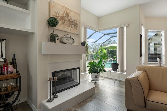 tiled living room with a tile fireplace