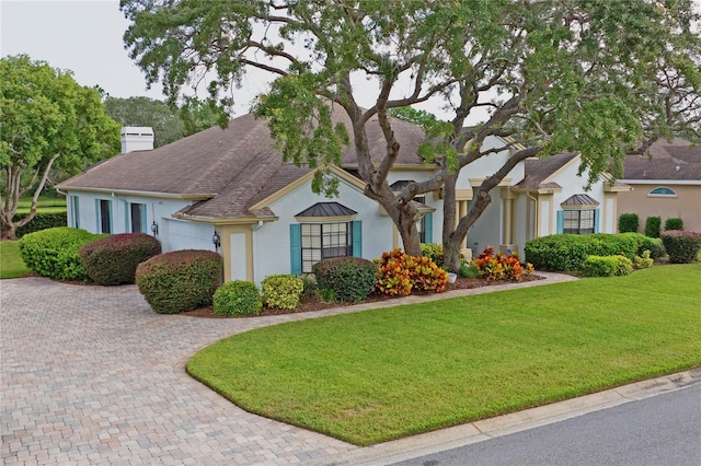 view of front of property featuring a garage and a front lawn