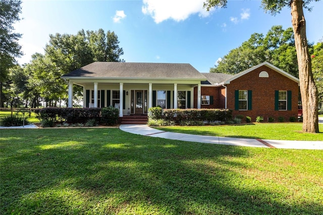 ranch-style home with a front yard and a porch