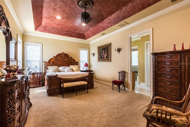 carpeted bedroom featuring a raised ceiling and ornamental molding