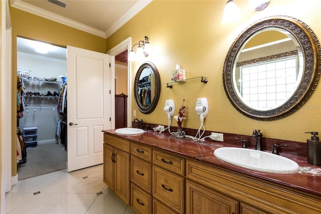 bathroom with tile patterned flooring, ornamental molding, and vanity