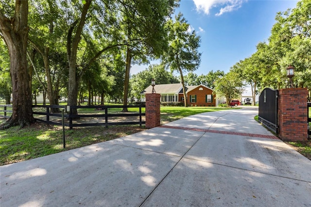 view of gate featuring a lawn