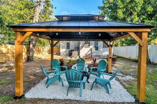 view of patio featuring a fire pit and a gazebo