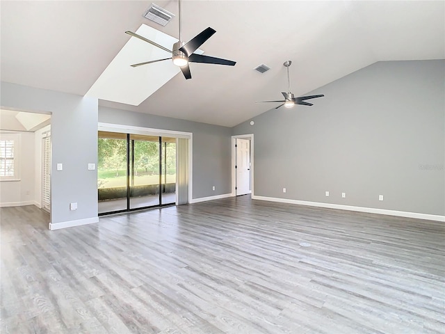 spare room featuring ceiling fan, light hardwood / wood-style floors, and a healthy amount of sunlight