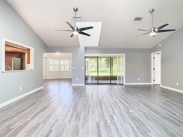 unfurnished living room featuring ceiling fan, hardwood / wood-style flooring, and high vaulted ceiling