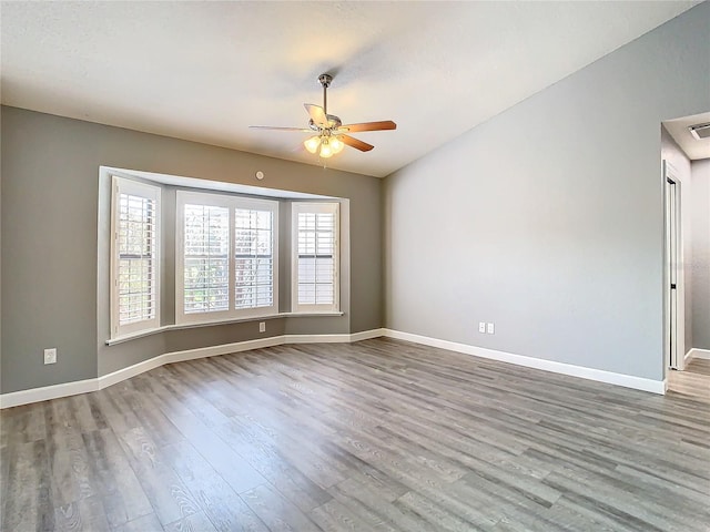 unfurnished room with vaulted ceiling, ceiling fan, and hardwood / wood-style flooring