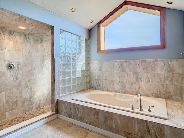 bathroom with tile patterned flooring and shower with separate bathtub