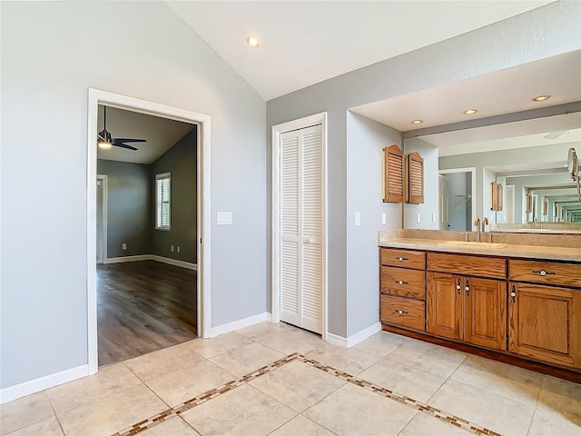 bathroom featuring tile patterned floors, vanity, lofted ceiling, and ceiling fan