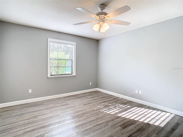 spare room featuring hardwood / wood-style floors, ceiling fan, and a textured ceiling