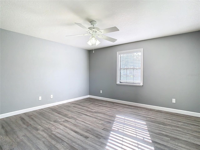 unfurnished room with a textured ceiling, ceiling fan, and hardwood / wood-style flooring