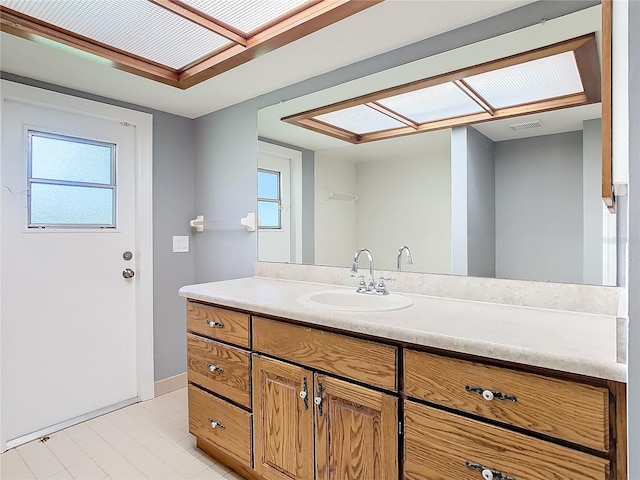 bathroom with tile patterned flooring and vanity