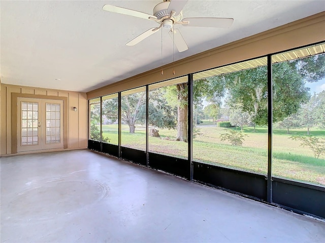 unfurnished sunroom with ceiling fan