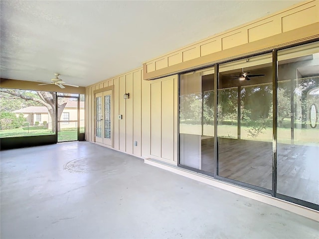 unfurnished sunroom featuring ceiling fan