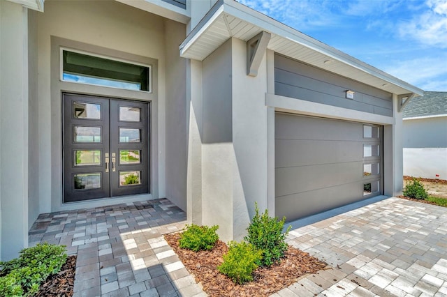 entrance to property featuring french doors and a garage