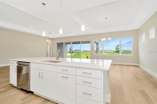 kitchen with light hardwood / wood-style flooring, a chandelier, hanging light fixtures, dishwashing machine, and sink