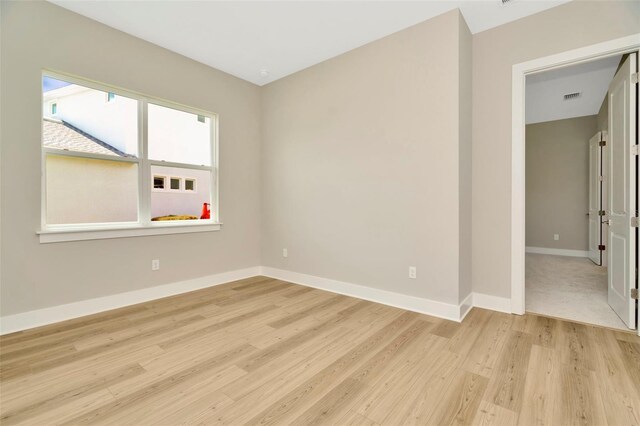 spare room with light wood-type flooring