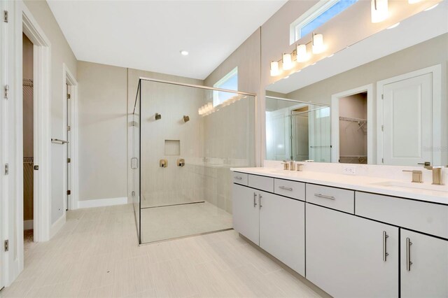 bathroom featuring tile patterned floors, walk in shower, and vanity