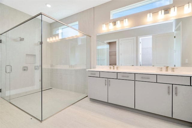 bathroom featuring an enclosed shower and vanity