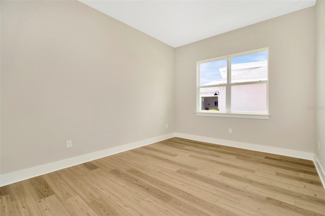 unfurnished room with light wood-type flooring