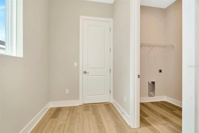 laundry area with electric dryer hookup and light hardwood / wood-style floors