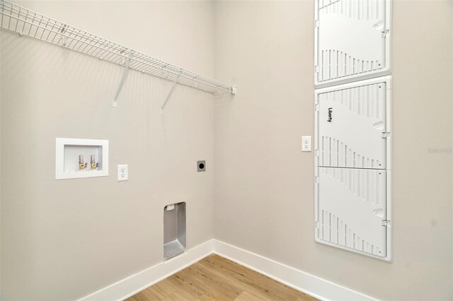 laundry area featuring light wood-type flooring, electric dryer hookup, and washer hookup