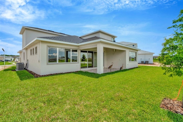 rear view of house featuring a lawn, cooling unit, and a patio