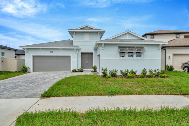 view of front of property with a garage and a front yard