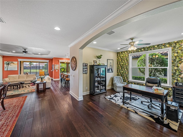 living room featuring dark wood-type flooring, a textured ceiling, and a wealth of natural light