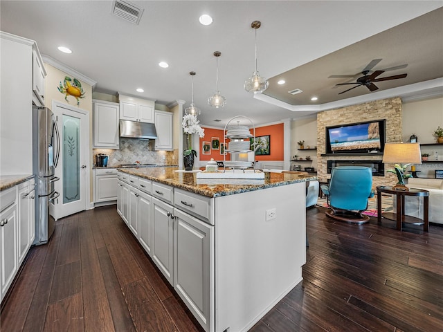 kitchen with white cabinets, ceiling fan, dark hardwood / wood-style flooring, and stone counters