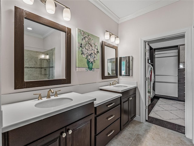 bathroom featuring a shower, tile patterned flooring, crown molding, and vanity