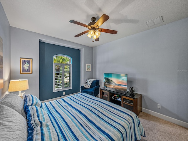 bedroom featuring a textured ceiling, ceiling fan, and carpet floors